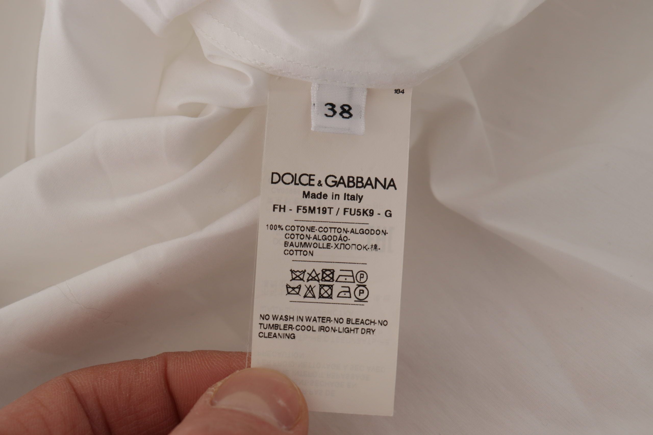 Dolce &amp; Gabbana Blouse de smoking élégante sans manches avec boutons en cristal